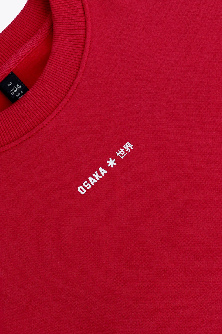 Osaka women sweater in red with logo in white. Front flatlay detail logo view