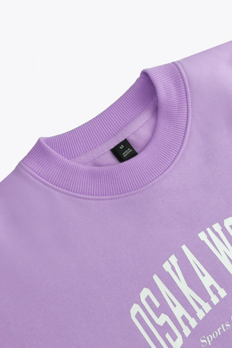 Osaka women sweater in light purple with logo in white. Front flatlay neck view