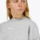 Osaka women sweater in heather grey with logo in white. Front detail logo view