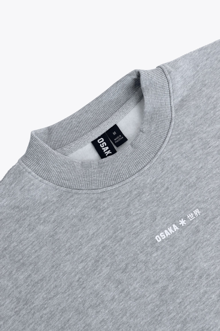 Osaka women sweater in heather grey with logo in white. Front flatlay detail neck view