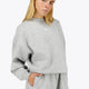 Woman wearing the Osaka women sweater in heather grey with logo in white. Front view