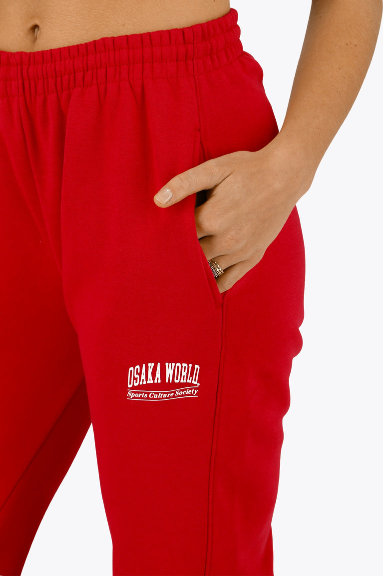 Osaka women sweatpants in red with logo in white. Front detail logo view
