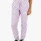 Woman wearing the Osaka women sweatpants in light purple with logo in white. Front view