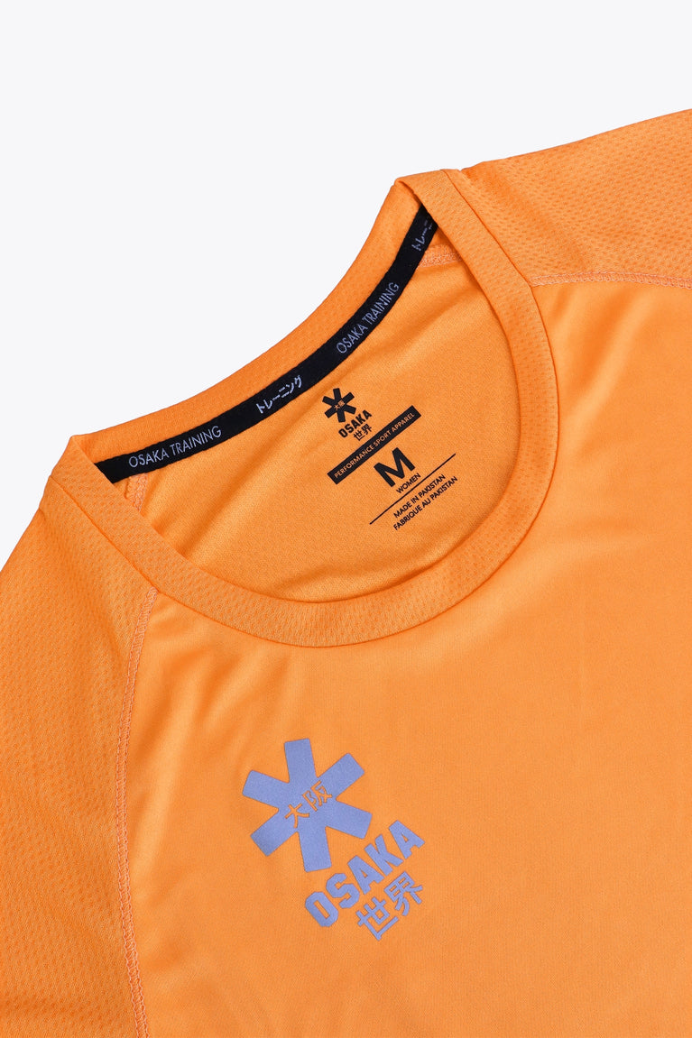 Osaka women tee short sleeve in orange with logo in grey. Front flatlay detail view