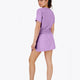 Woman wearing the Osaka women tee short sleeve in light purple with logo in grey. Back view