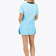 Woman wearing the Osaka women tee short sleeve in light blue with logo in grey. Back view