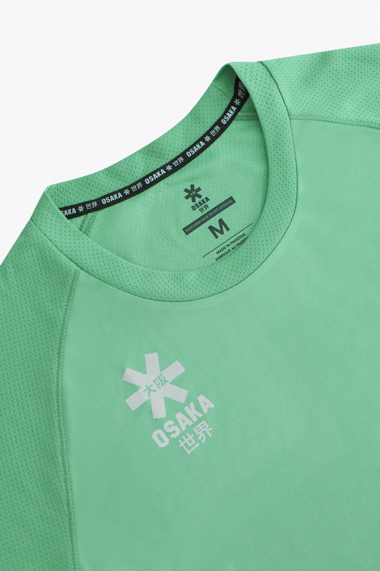 Osaka women tee short sleeve in green with logo in grey. Front flatlay detail view