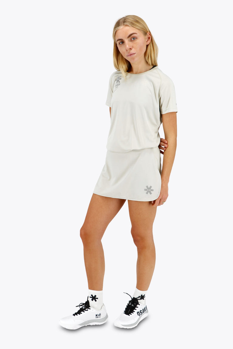 Woman wearing the Osaka women tee short sleeve in light grey with logo in grey. Front view