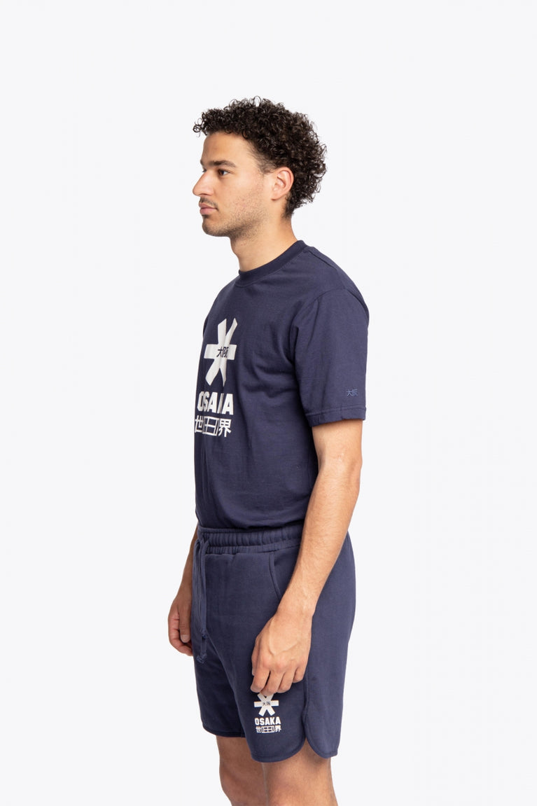 Man wearing the Osaka court classic short in navy with white logo. Side full view