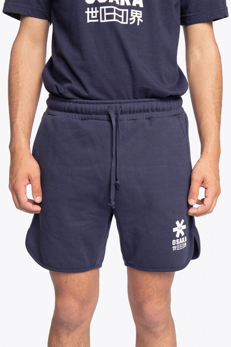 Man wearing the Osaka court classic short in navy with white logo. Front view