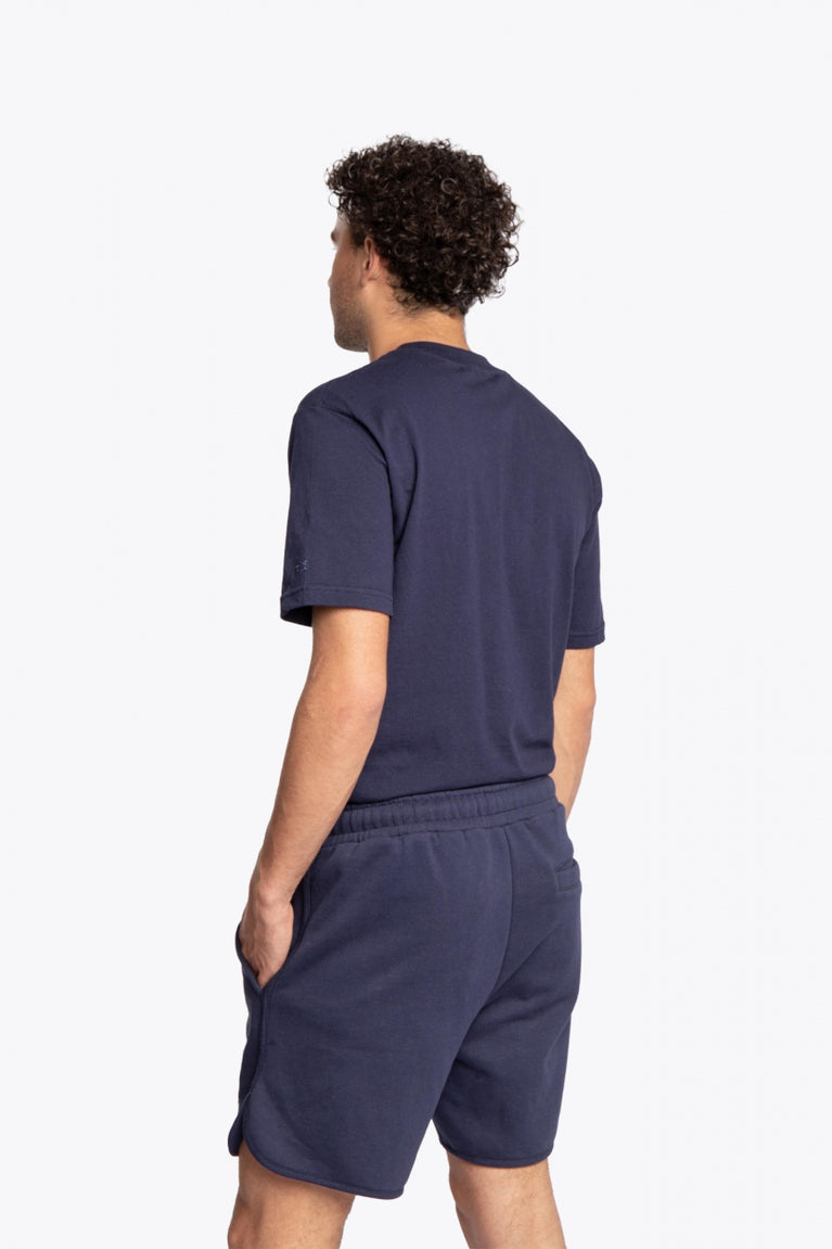 Man wearing the Osaka court classic short in navy with white logo. Back full view