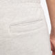 Man wearing the Osaka Men padel shorts in grey with green logo on it. Detail back pocket view