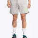 Man wearing the Osaka Men padel shorts in grey with green logo on it. Front view