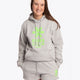 Woman wearing the Osaka basic unisex hoodie in grey with green logo on it. Front view