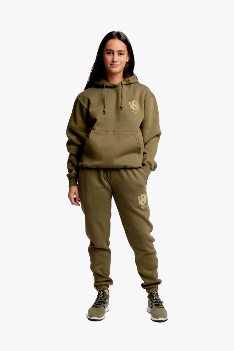 Girl wearing the Osaka unisex hoodie in army green with college initials in yellow. Front full view