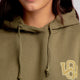 Girl wearing the Osaka unisex hoodie in army green with college initials in yellow. Front detail logo view