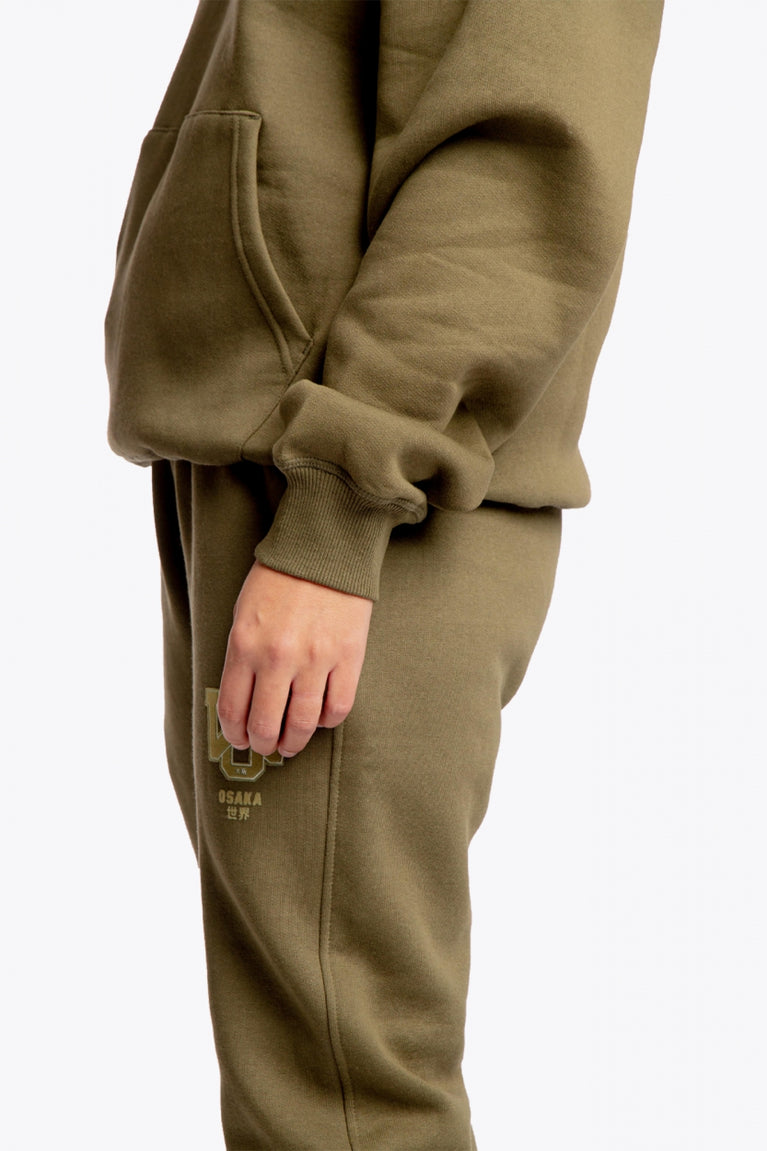 the Osaka unisex hoodie in army green with college initials in yellow. Detail side sleeve view