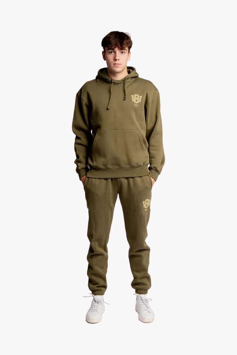 Boy wearing the Osaka unisex hoodie in army green with college initials in yellow. Front full view