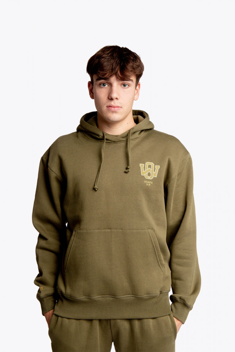 Boy wearing the Osaka unisex hoodie in army green with college initials in yellow. Front view