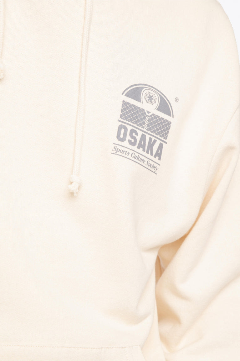 the Osaka unisex cream hoodie sports culture society with logo in dark grey. Front detail logo view