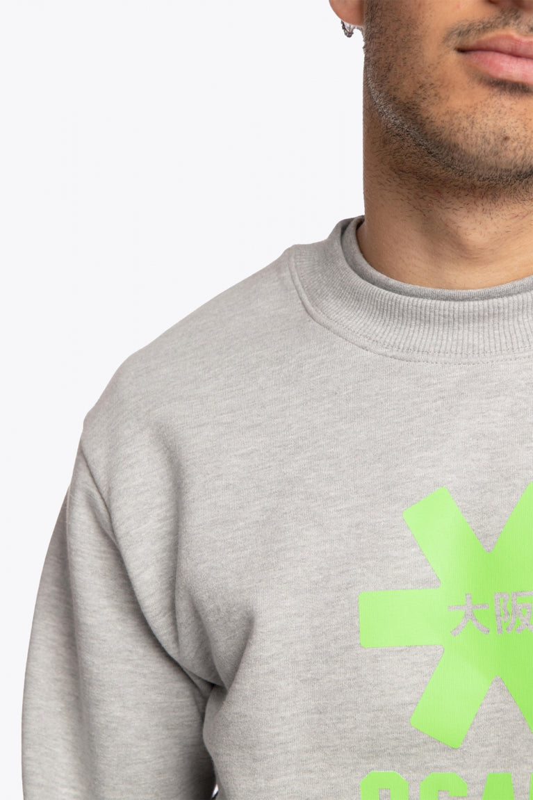 The Osaka grey unisex sweater with green logo. Front detail shoulder view