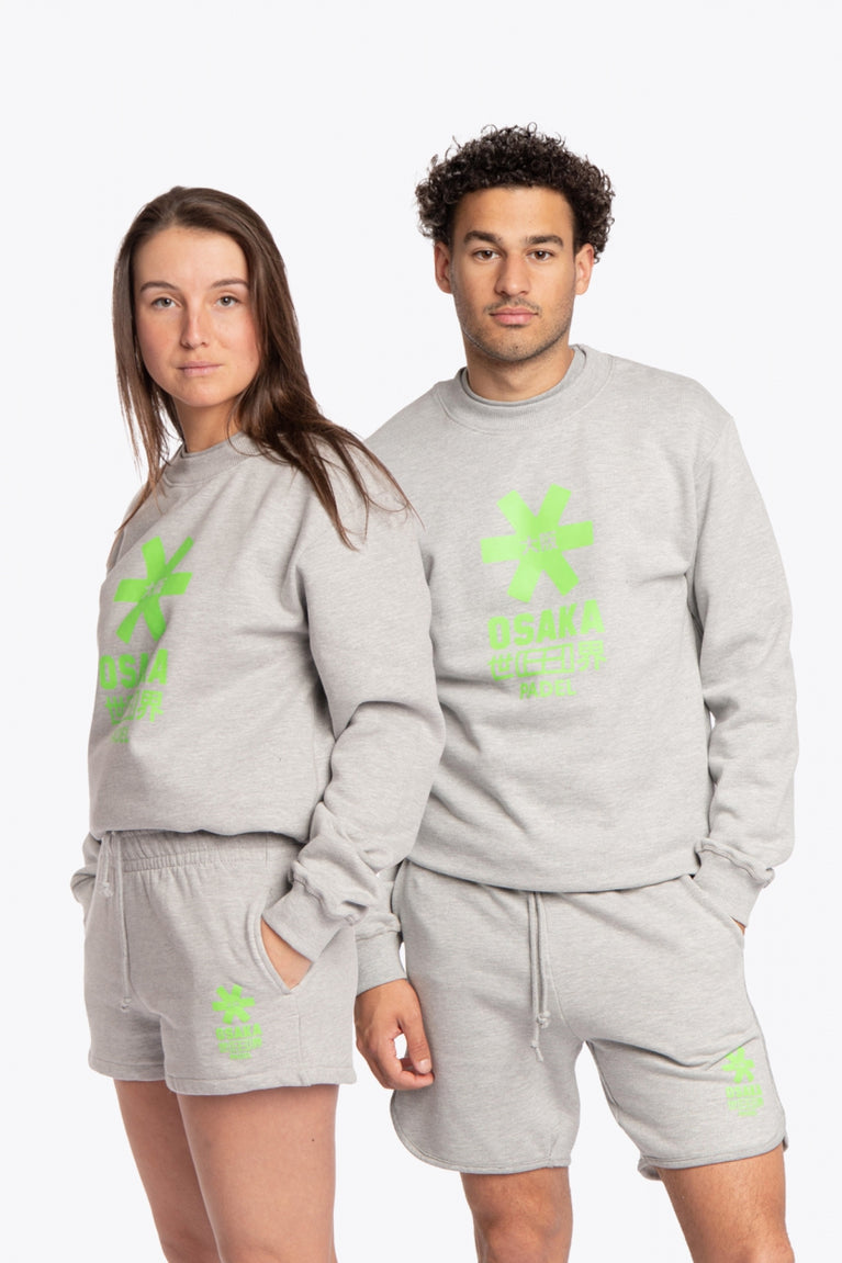 Man and woman wearing the Osaka grey unisex sweater with green logo. Front view
