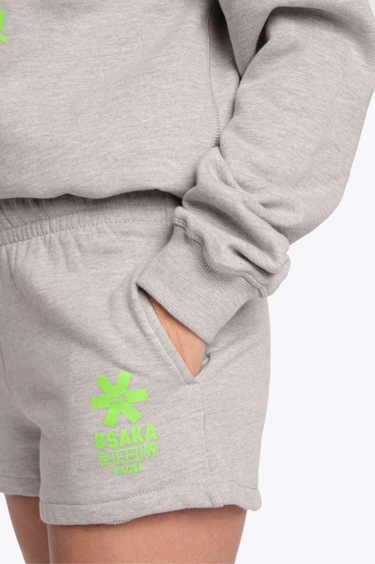 The Osaka grey unisex sweater with green logo. Front detail sleeveview