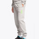 Men wearing the Osaka unisex sweatpants in heather grey with logo in green. Side view