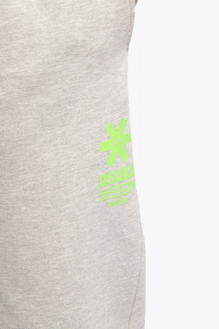 Osaka unisex sweatpants in heather grey with logo in green. Detail logo view