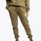Model wearing the Osaka unisex sweatpants in army green with logo in yellow. Front view