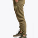 Model wearing the Osaka unisex sweatpants in army green with logo in yellow. Side view