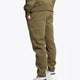 Model wearing the Osaka unisex sweatpants in army green with logo in yellow. Back side view