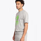 Man wearing the Osaka unisex tee in heather grey with green logo. Side front view