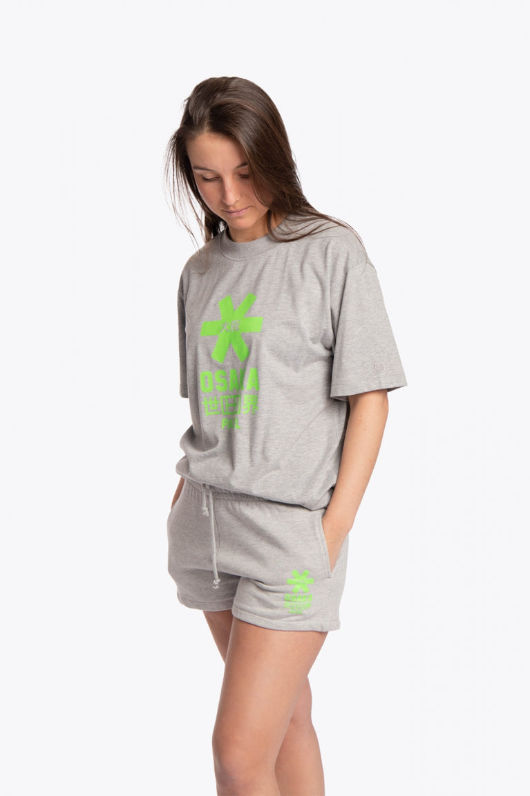 Woman wearing the Osaka unisex tee in heather grey with green logo. Front view