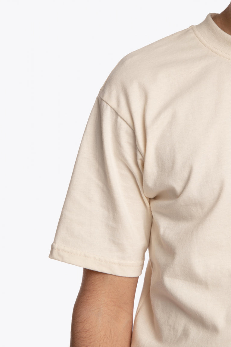 Osaka unisex tee in cream with logo in grey. Detail sleeve view