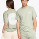 Woman and man wearing the Osaka unisex tee in iceberg green with white logo. Front and back view