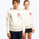 Boy and girl wearing the Osaka kids hoodie in natural raw with college letters in orange and logo in blue. Front view