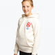 Girl wearing the Osaka kids hoodie in natural raw with college letters in orange and logo in blue. Front/side view