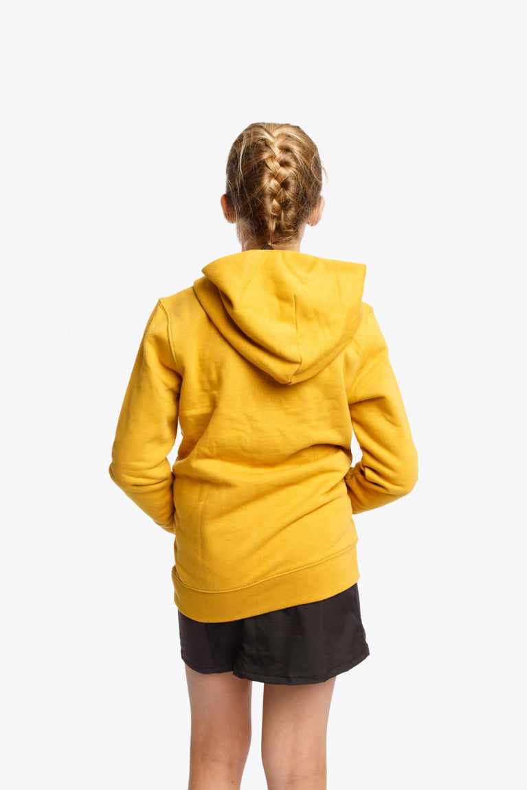 Girl wearing the Osaka kids hoodie in ochre and marker logo in white. Back view