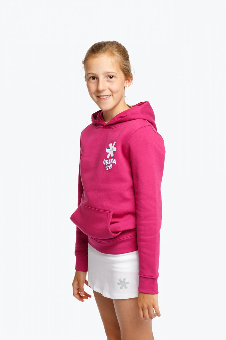 Girl wearing the Osaka kids hoodie in pink and off-set star logo in white and blue. Front/side view