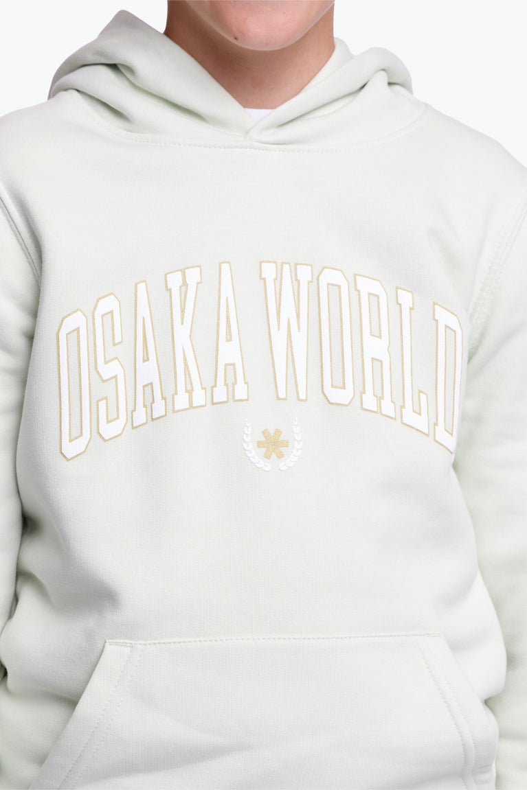 Osaka kids hoodie in mint green with logo in college letters in white. Detail view logo