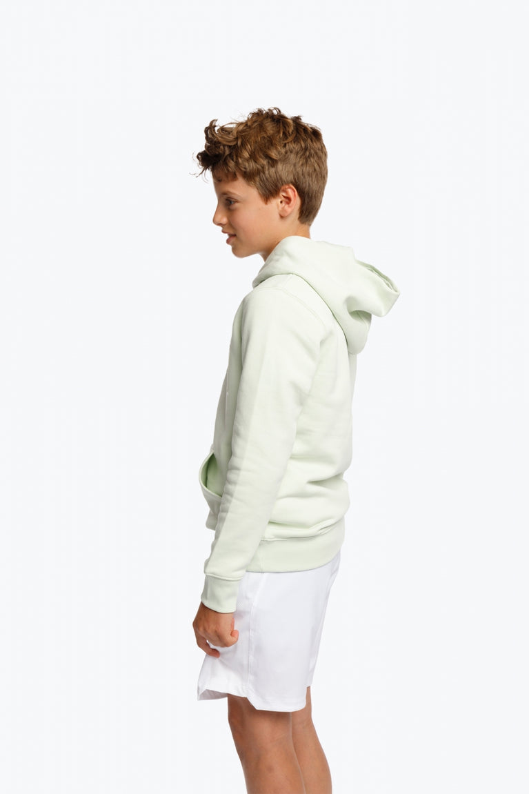 Boy wearing the Osaka kids hoodie in mint green with logo in college letters in white. Side view