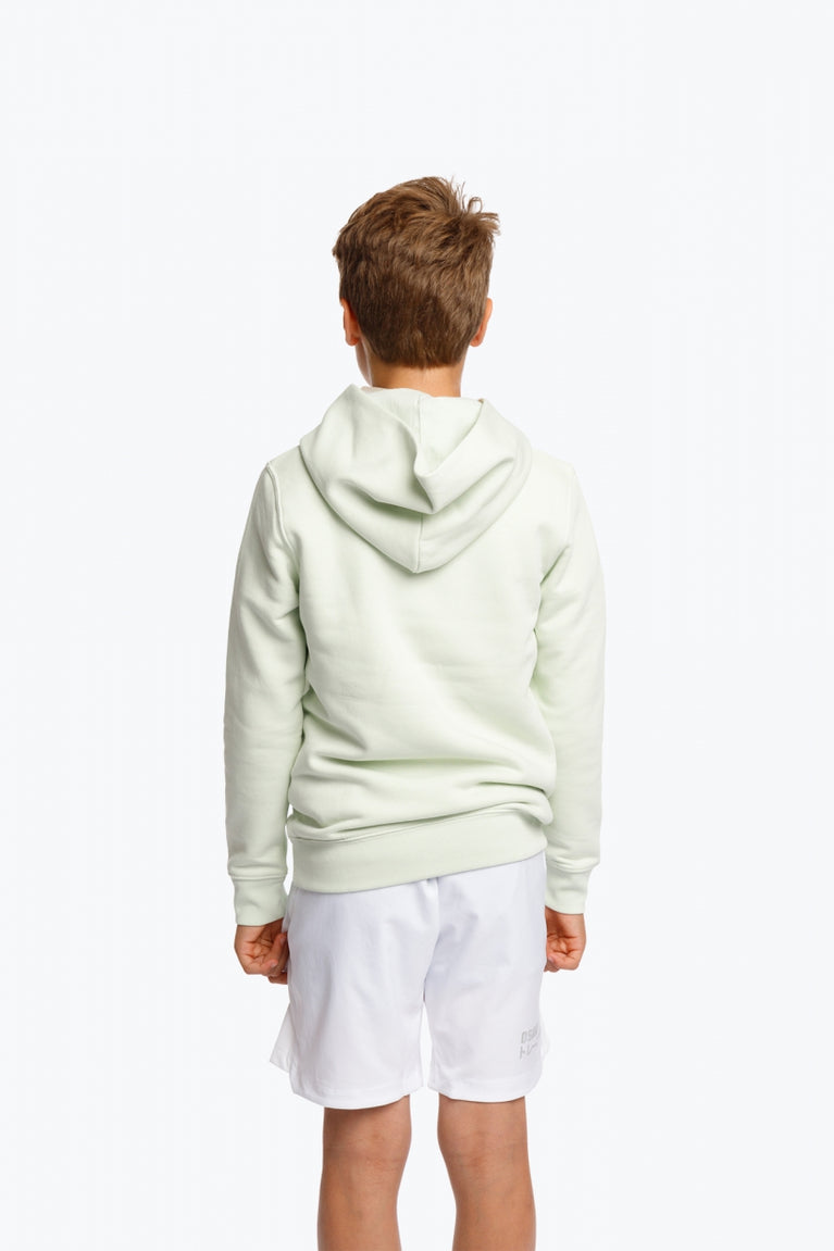 Boy wearing the Osaka kids hoodie in mint green with logo in college letters in white. Back view