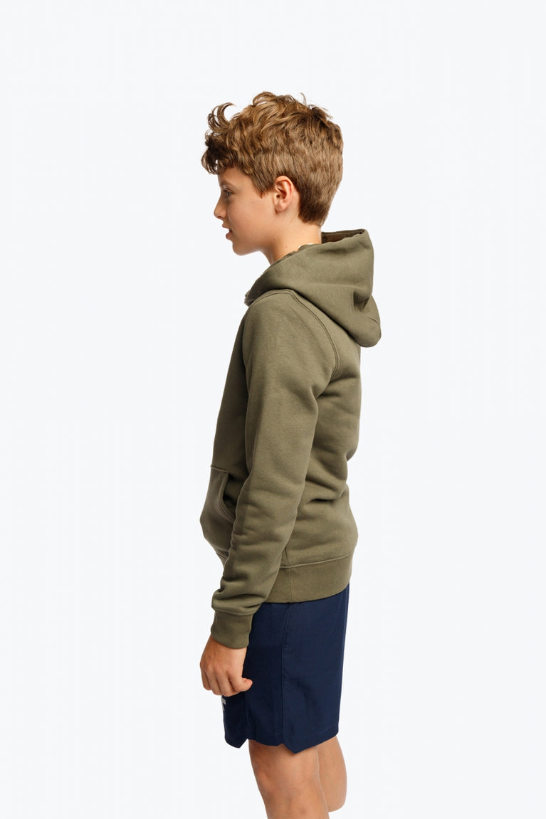 Boy wearing the Osaka kids hoodie in khaki with yellow logo. Side view