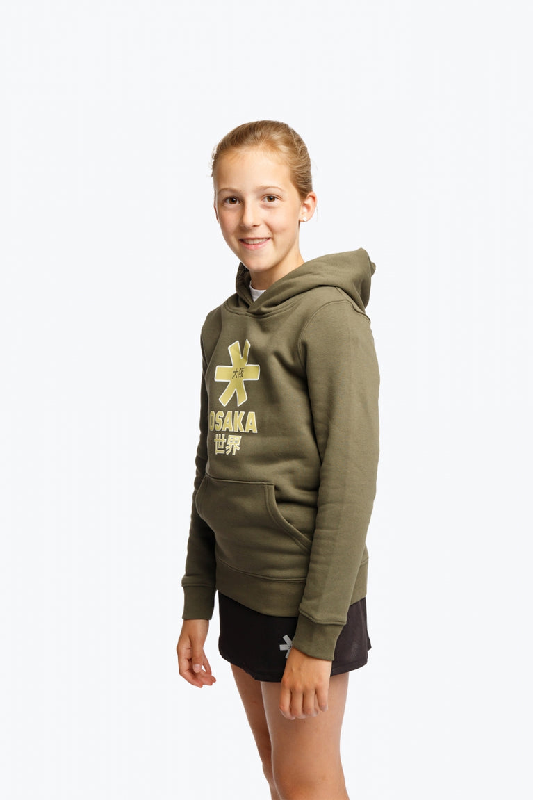 Girl wearing the Osaka kids hoodie in khaki with yellow logo. Side/front view