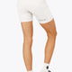 Woman wearing the Osaka women tech short thights in white with grey logo. Back view