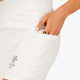 Woman wearing the Osaka women tech short thights in white with grey logo. Front detail pocket view