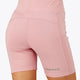 Woman wearing the Osaka women tech short thights in pink with grey logo. Back view