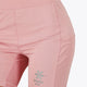 Woman wearing the Osaka women tech short thights in pink with grey logo. Front view