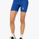Woman wearing the Osaka women tech short thights in princess blue with grey logo. Front view